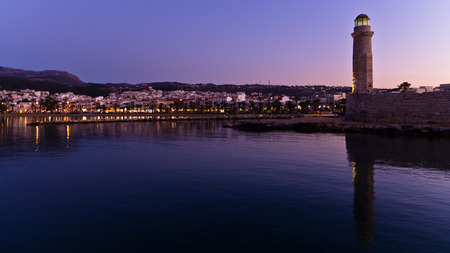 Old venetian harbor with lighthouse at twilight, city of Rethymno, island of Crete, Greeceの写真素材