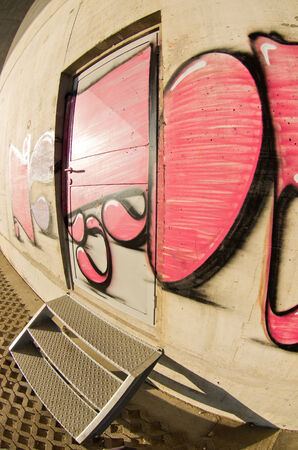 Red Grafitti on a concrete wall at sunny morning, Belgrade, Serbiaのeditorial素材