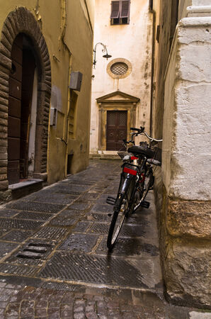 Backstreet and a bicycle in Lucca, Tuscany, Italyの写真素材