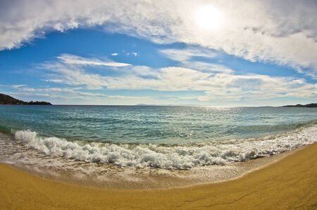 Fish eye view of a beautiful sandy beach at small greek village Toroni, Sithonia, Greeceの写真素材