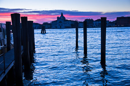 Red sky at sunrise in Venice near Grand Canal, San Giorgio Maggiore church in background, Italyの写真素材