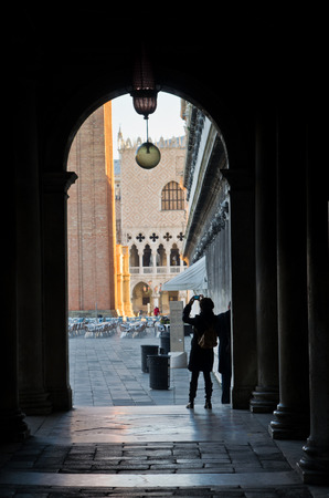 Tourist taking photos at the entrance to piazza San Marco, Venice, Italyの写真素材