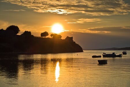 Sunset at Toroni bay near old roman fortress in Sithonia, Greeceの写真素材