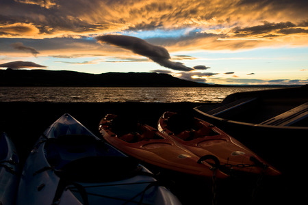 Boats by the lake Laugarvatn at sunrise, Iceland. The lake Laugarvatn contains geothermal springs under its surface, making it a popular swimming spot.の写真素材