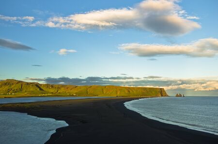 Sunset on a black beach, a view from Dyrholaey rock near Vik at south Iceland