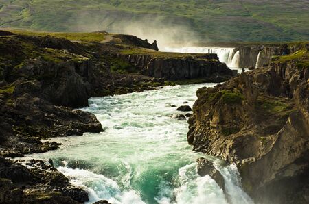 Glacial river with Godafoss waterfall in background, north Icelandの写真素材