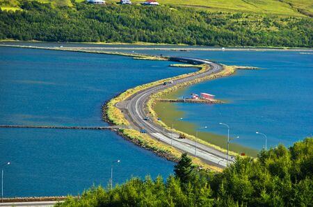 Road accross fjord at city of Akureyri, north Icelandの写真素材