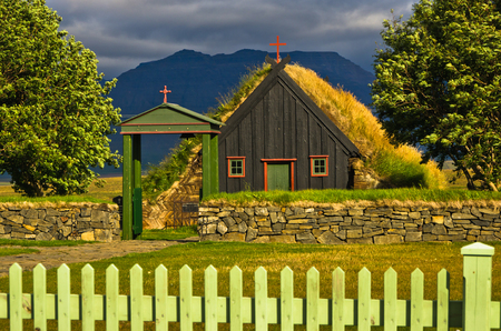 Vdimyrarkirkja turf and wooden church built in 1834 at summer sunny day in Skagafjordur, north Icelandの写真素材