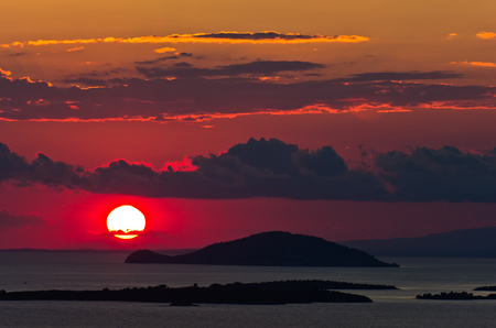 Sunset at sea, with small greek islands in background, Sithonia, Greeceの写真素材