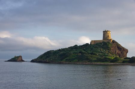Tower Coltellazzo of Saint Efisio lighthouse at Nora archeological site, gulf of Cagliari, Sardinia, Italyの写真素材