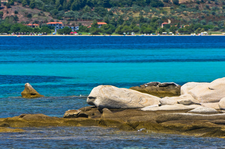 Emerald green sea water at coast of small uninhabited island near coast of Sithonia, Greeceの写真素材