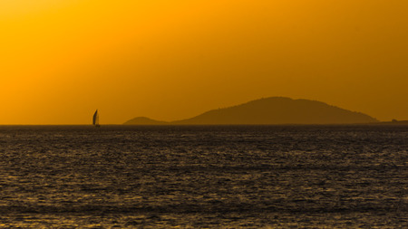 Sunset at sea, with small greek islands in background, Sithonia, Greeceの写真素材
