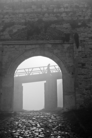 Fortress gate and wooden bridge in fog at autumn morning, Kalemegdan, Belgrade, Serbiaのeditorial素材