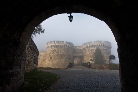 Fortress gates and towers in fog at autumn sunny morning, Kalemegdan, Belgrade, Serbiaのeditorial素材