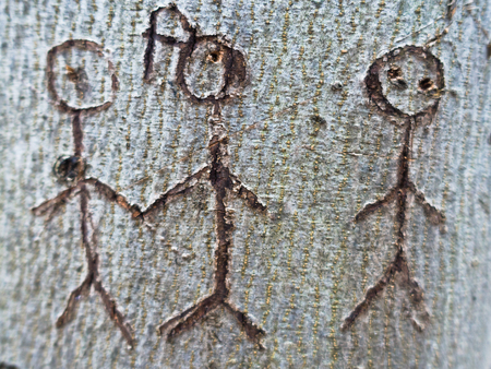 Symbol of a group of people carved in tree bark
