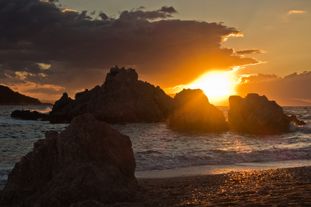 Sea rocks with dramatic clouds at sunset , Kastani Mamma Mia beach, island of Skopelos, Greeceの写真素材