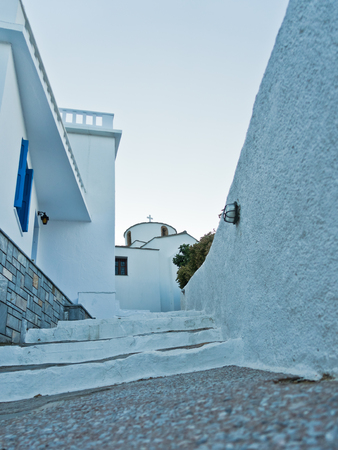 Small church on a top of a hill above Skopelos bay and harbor, Skopelos island in Greeceの写真素材