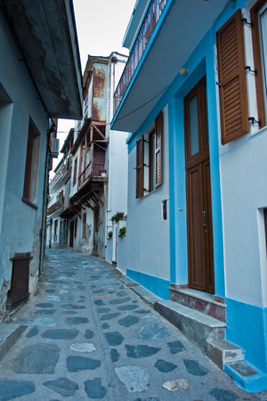 Narrow, winding and steep cobblestone streets at sunset, city of Skopelos, Skopelos island in Greeceの写真素材