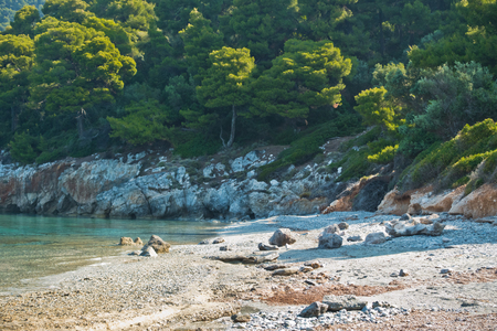 Sea rocks at calm and crystal clear turquoise water at morning, Milia beach, island of Skopelos, Greeceの写真素材