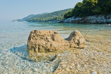 Sea rocks at calm and crystal clear turquoise water at morning, Milia beach, island of Skopelos, Greeceの写真素材