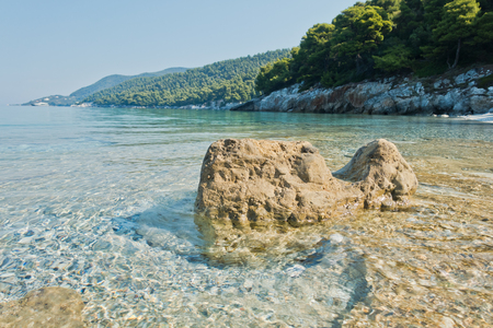 Sea rocks at calm and crystal clear turquoise water at morning, Milia beach, island of Skopelos, Greeceの写真素材