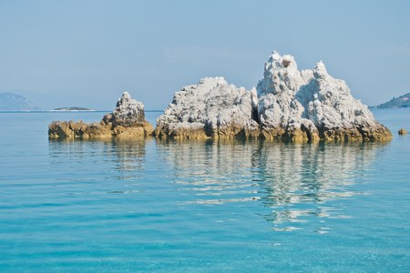 Sea rocks at calm and crystal clear turquoise water at morning, Milia beach, island of Skopelos, Greeceの写真素材