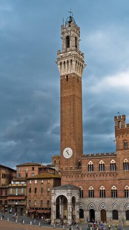Torre del Mangia, clock tower of a city hall on Piazza del Campo main square in Siena, Tuscany, Italyの写真素材