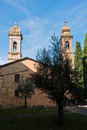 Bell towers of San Quirico church at sunny morning in San Quirico d'Orcia , Siena province, Tuscany, Italyの写真素材