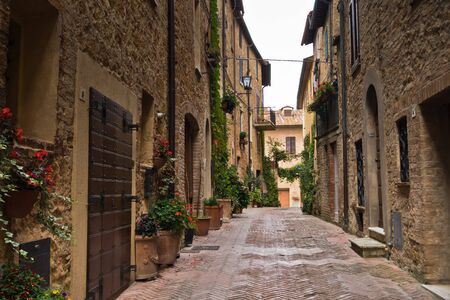 Narrow streets with romantic medieval architecture at city of Pienza, Siena province, Tuscany, Italyの写真素材