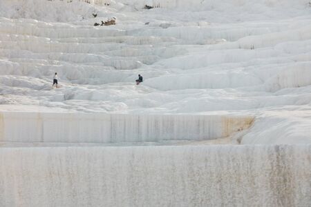 Details of white carbonate mineral rocks made by water flow at Pamukkale near archelological site Hierapolis, Denizli, Turkeyの写真素材