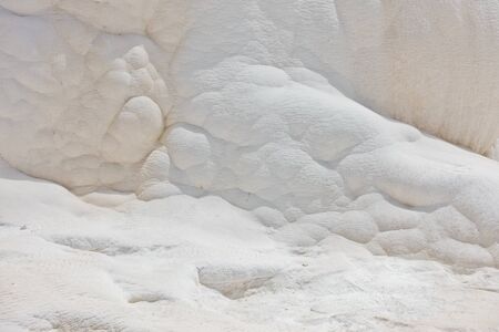 Details of white carbonate mineral rocks made by water flow at Pamukkale near archelological site Hierapolis, Denizli, Turkeyの写真素材