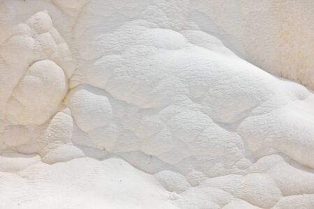 Details of white carbonate mineral rocks made by water flow at Pamukkale near archelological site Hierapolis, Denizli, Turkeyの写真素材