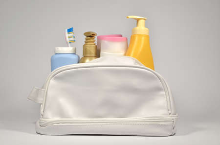Different cosmetic containers  in white cosmetic bagの写真素材
