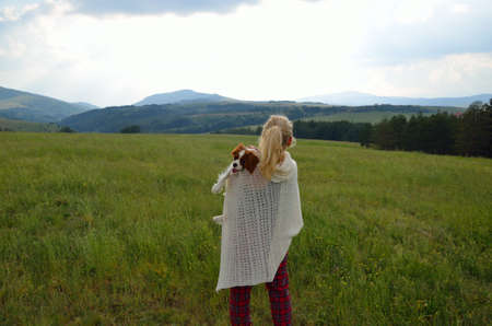 Lady with her cavalier king charles spaniel in the mountainsの写真素材
