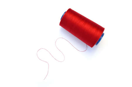 Red thin thread  set on white backgroundの写真素材