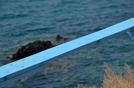 Blue plank with sea and rock in backgroundの写真素材