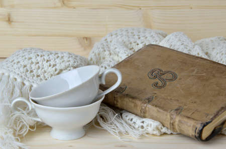 Granny's stuffs - vintage nineteenth century coffee cups with hand-knitted scarf - and my old diary notebook of which I am the authorの写真素材