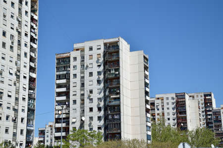Line of residential buildings under clear spring sky