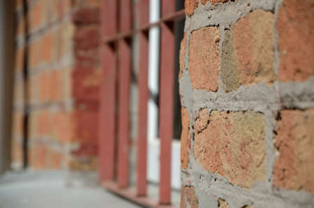 Window in brick wall protected with iron bars