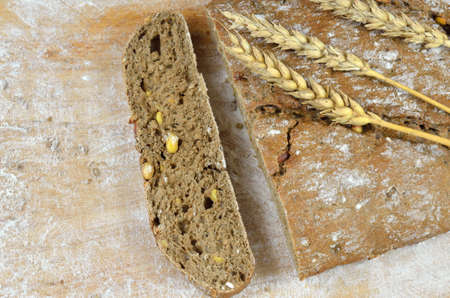 Dark rustic bread and wheat ears on top
