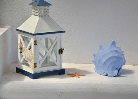 Lamp and sea shell in Mediterranean style as decorationの写真素材