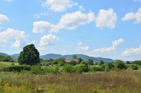 Two old village houses in picturesque landscape in central Serbiaの写真素材