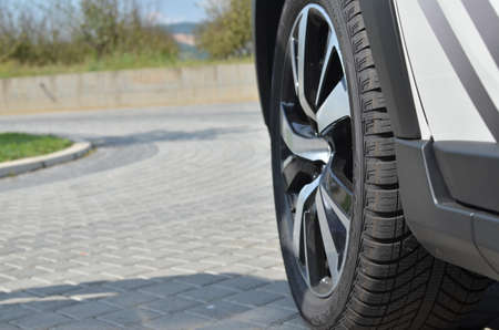 Jagodina, Serbia - September 12, 2016: Wheel with a black tyre on a car parked on a pavementの写真素材