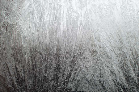 Surface of a window glass with frostwork as a backgroundの写真素材