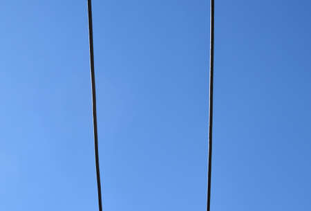 Grey iron bars against clear blue skyの写真素材