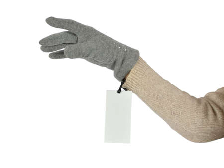 Woman's hand in a grey woolen glove with a price tag on white background