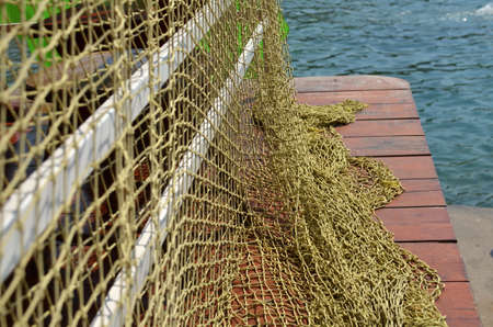 Large fishing net on a mall with sea in background