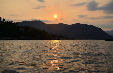 Dawn over a sea surface with sun reflectionsの写真素材