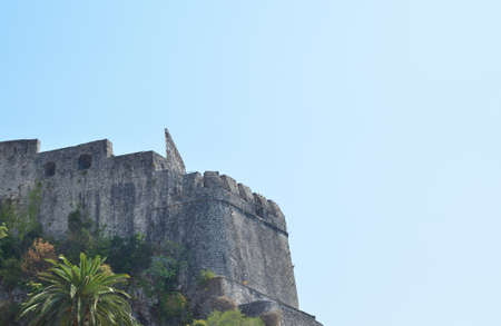 Medieval fortress on a hill above a town and skyの写真素材