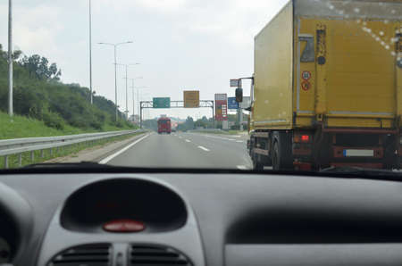 Driving on a highway with other vehicles in his directionの写真素材